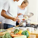 A man and a woman cooking together